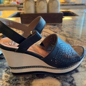 Clarks wedge sandal. Black cut out leather upper/canvas heel. Super comfortable